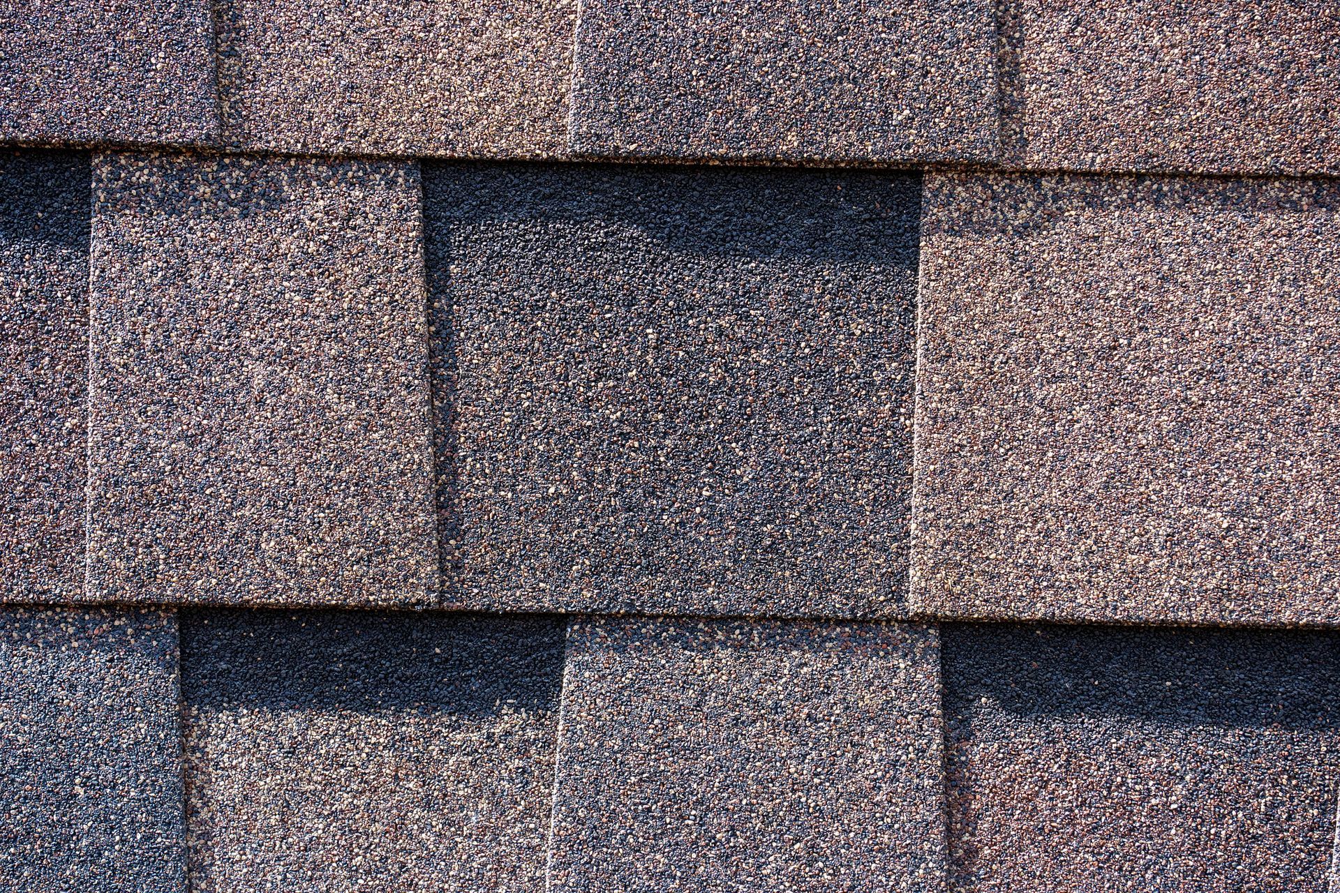 Close-up of layered architectural asphalt shingles.